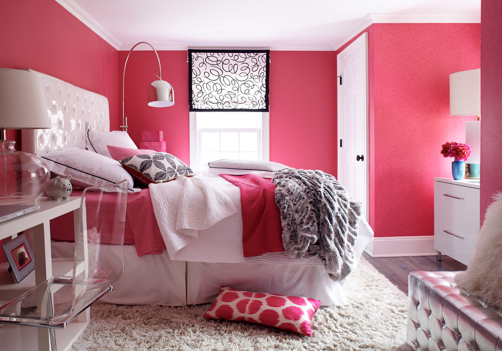 This is an example of a transitional bedroom in New York with pink walls.