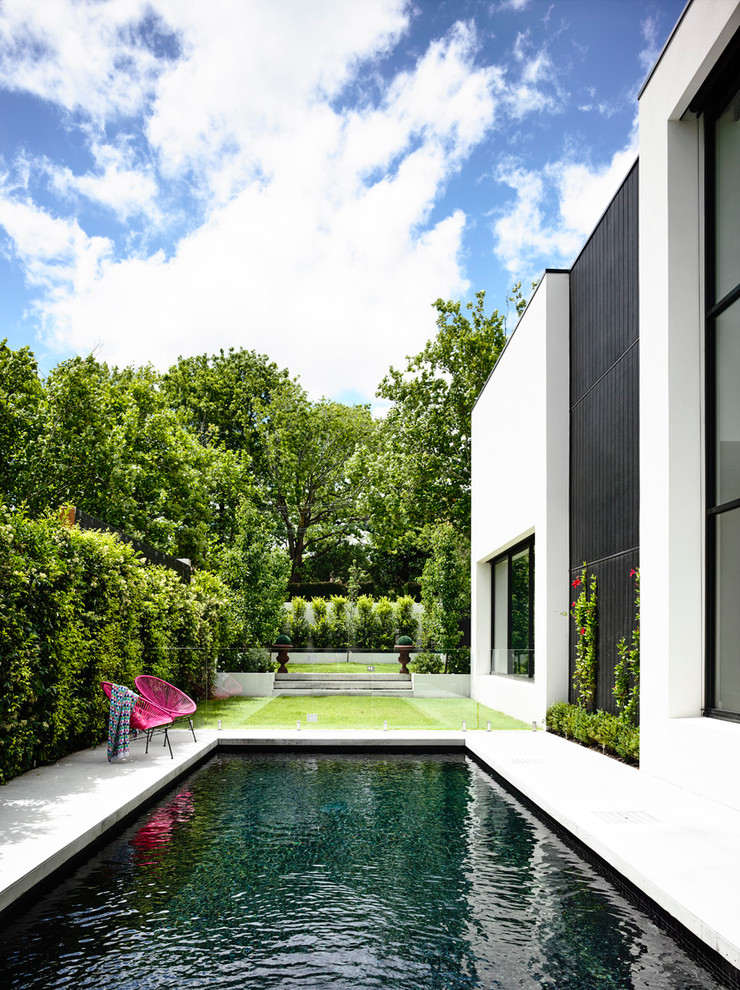 Design ideas for a contemporary backyard rectangular lap pool in Melbourne with concrete slab.