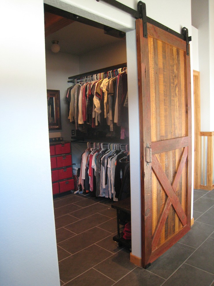 This is an example of a large country gender-neutral walk-in wardrobe in Denver with grey floor and slate floors.
