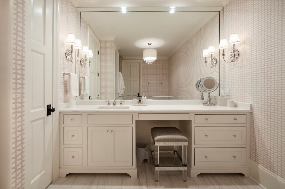 This is an example of a mid-sized traditional kids bathroom in Nashville with beaded inset cabinets, white cabinets, a freestanding tub, porcelain floors, an undermount sink, quartzite benchtops, white floor, pink benchtops, a single vanity, a built-in vanity and wallpaper.