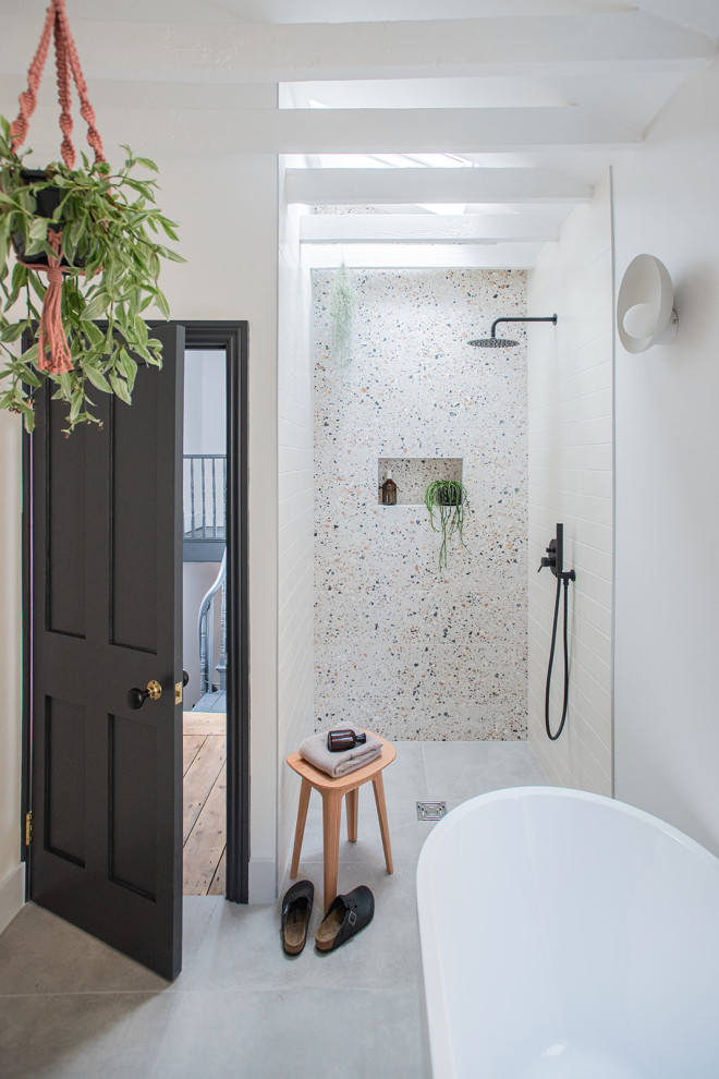 Inspiration for a mid-sized contemporary kids bathroom in London with a freestanding tub, an open shower, a wall-mount toilet, beige tile, porcelain tile, multi-coloured walls, cement tiles, a wall-mount sink, wood benchtops, grey floor, an open shower, a single vanity and exposed beam.