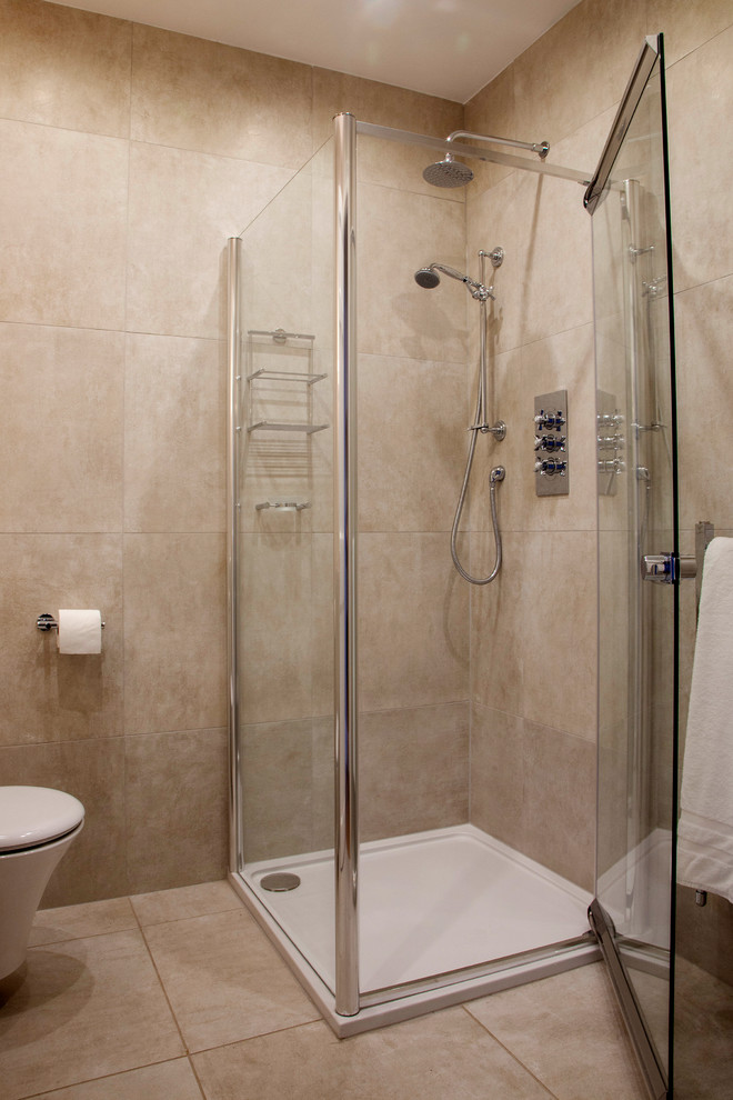Photo of a small contemporary 3/4 bathroom in Other with recessed-panel cabinets, ceramic tile, an open shower, a wall-mount toilet, beige tile, beige walls and ceramic floors.