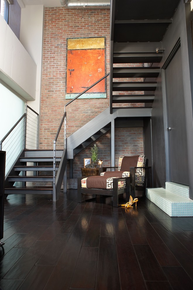 Design ideas for a mid-sized industrial wood u-shaped staircase in Phoenix with open risers.