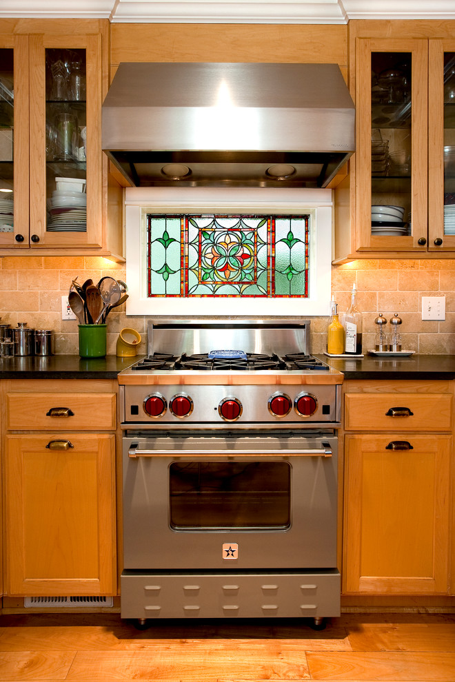 Inspiration for an arts and crafts kitchen in Seattle with shaker cabinets, medium wood cabinets, solid surface benchtops, ceramic splashback, stainless steel appliances and medium hardwood floors.