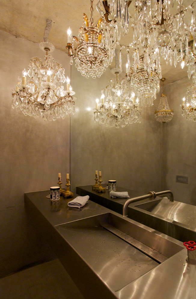 Photo of a contemporary powder room in Sydney with stainless steel benchtops, an integrated sink and grey walls.