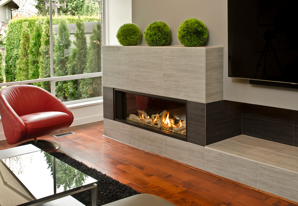 Inspiration for a bronze and mid-sized contemporary metal, formal and enclosed gas and medium tone wood floor living room remodel in Columbus with a remote control, beige walls, a standard fireplace, a stone fireplace and a wall-mounted tv