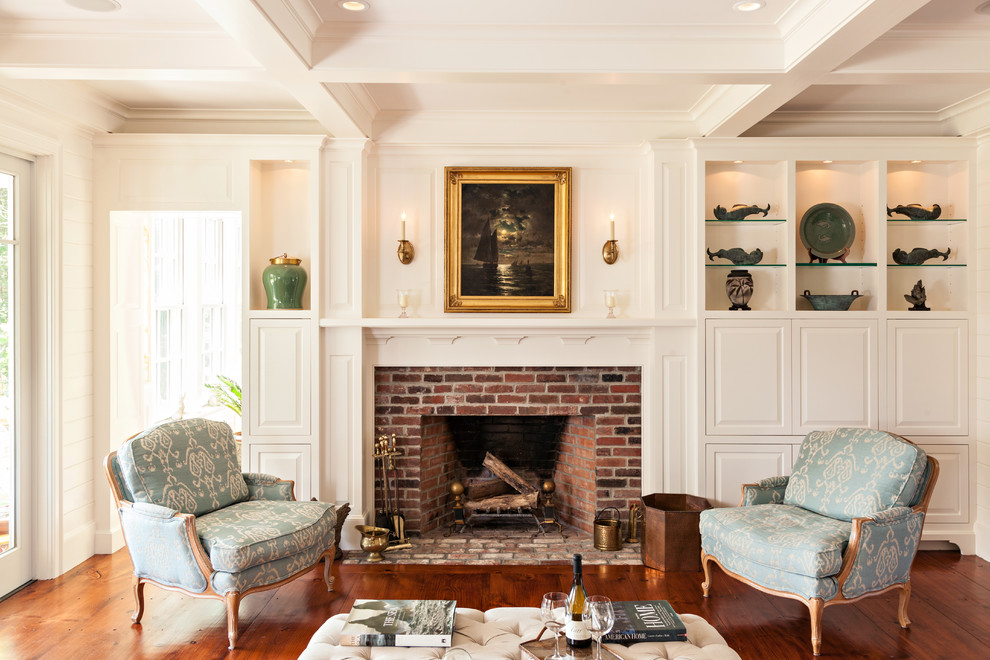 Design ideas for a traditional formal enclosed living room in Boston with white walls, medium hardwood floors, a standard fireplace and a brick fireplace surround.
