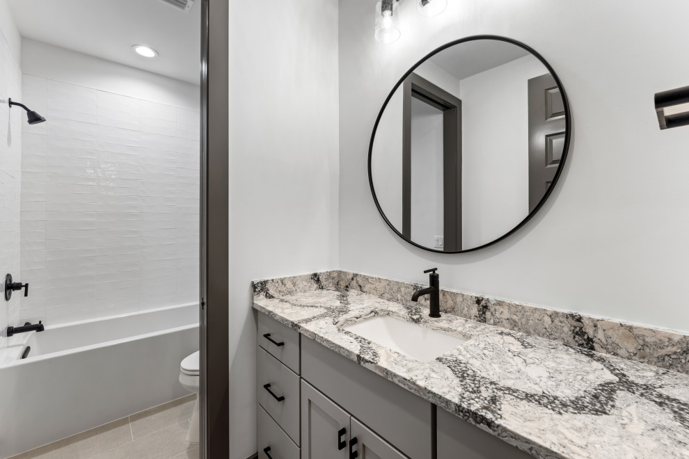 Inspiration for a mid-sized transitional kids' single-sink alcove bathtub remodel with recessed-panel cabinets, gray cabinets, an undermount sink, gray countertops and a built-in vanity