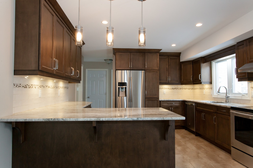 Inspiration for a mid-sized transitional u-shaped porcelain tile eat-in kitchen remodel in Toronto with an undermount sink, recessed-panel cabinets, dark wood cabinets, granite countertops, white backsplash, porcelain backsplash, stainless steel appliances and a peninsula