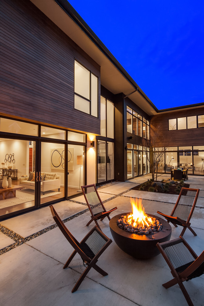 Design ideas for a contemporary patio in Seattle with a fire feature, concrete slab and no cover.