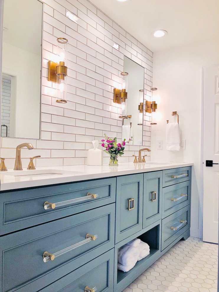 Inspiration for a mid-sized transitional kids' white tile and ceramic tile marble floor, gray floor and double-sink drop-in bathtub remodel in Atlanta with recessed-panel cabinets, blue cabinets, a two-piece toilet, white walls, an undermount sink, quartz countertops, white countertops, a niche and a built-in vanity