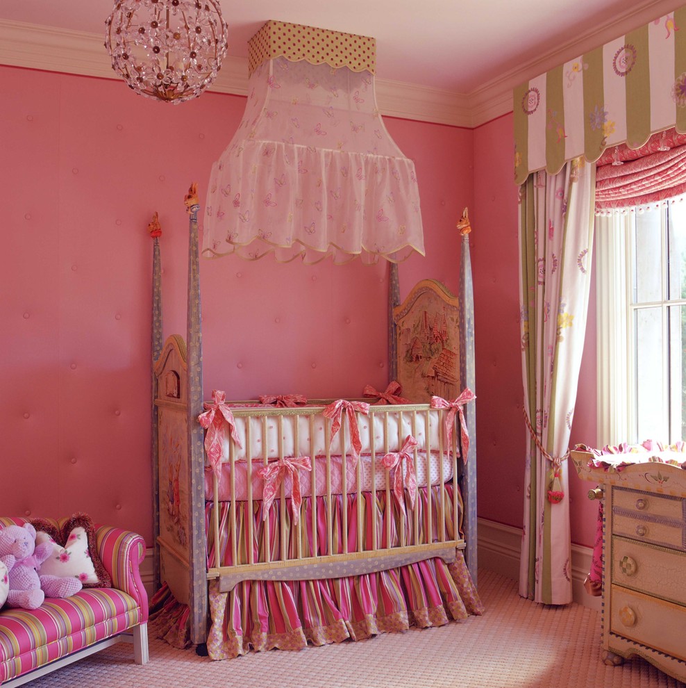 This is an example of a traditional nursery for girls in Orange County with pink walls and carpet.