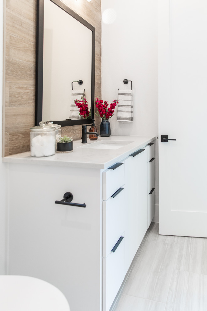 Design ideas for a mid-sized modern kids bathroom in Austin with a drop-in tub, a shower/bathtub combo, a two-piece toilet, brown tile, porcelain tile, brown walls, ceramic floors, a drop-in sink, granite benchtops, grey floor, a shower curtain and white benchtops.