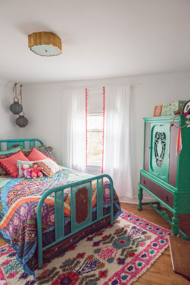 Mid-sized eclectic girl light wood floor kids' room photo in Chicago with white walls