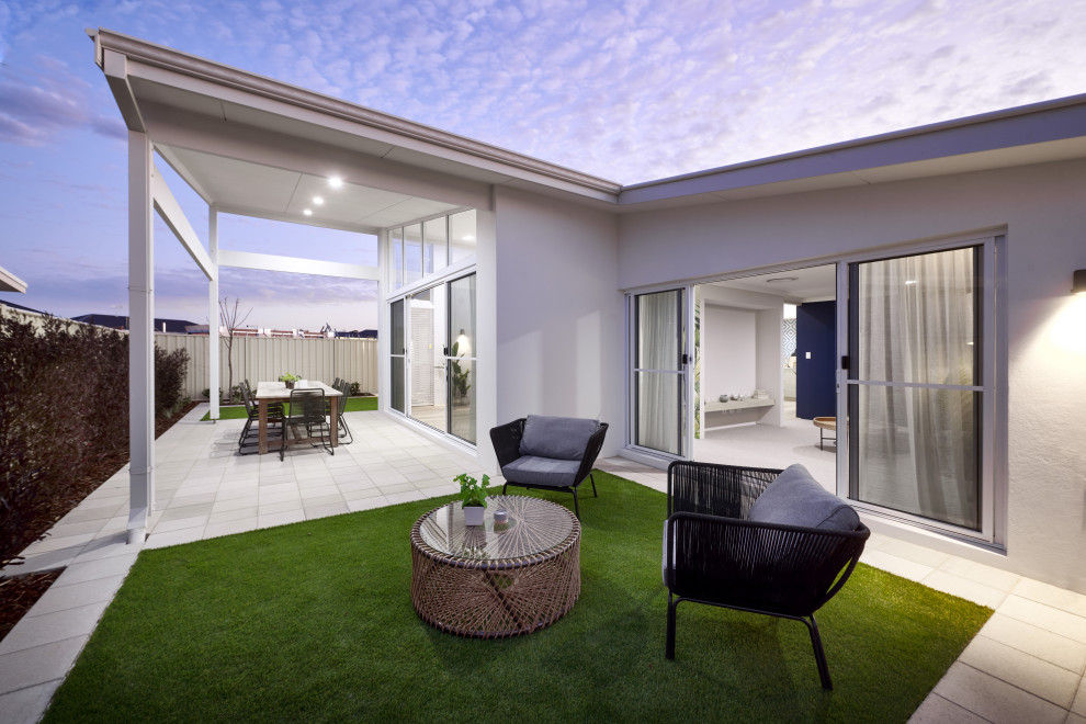 Mid-sized beach style backyard verandah in Perth with brick pavers and a roof extension.