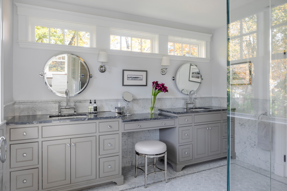 Large transitional master bathroom in Boston with recessed-panel cabinets, grey cabinets, a corner shower, a one-piece toilet, gray tile, mosaic tile, grey walls, mosaic tile floors, marble benchtops, grey floor, a hinged shower door, an undermount sink and grey benchtops.