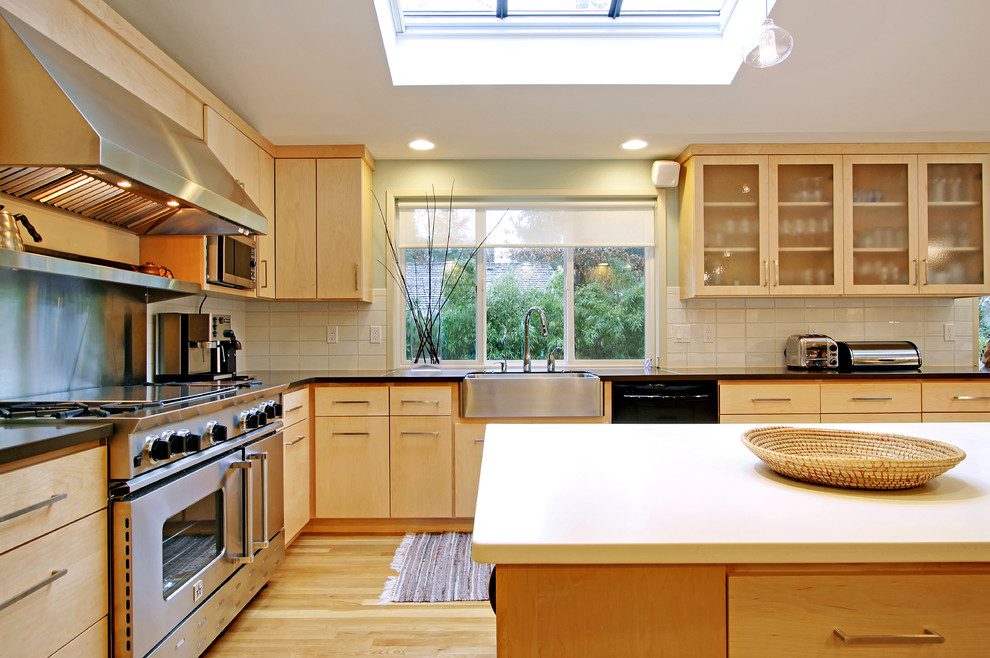 Design ideas for a contemporary kitchen in Seattle with a farmhouse sink and stainless steel appliances.