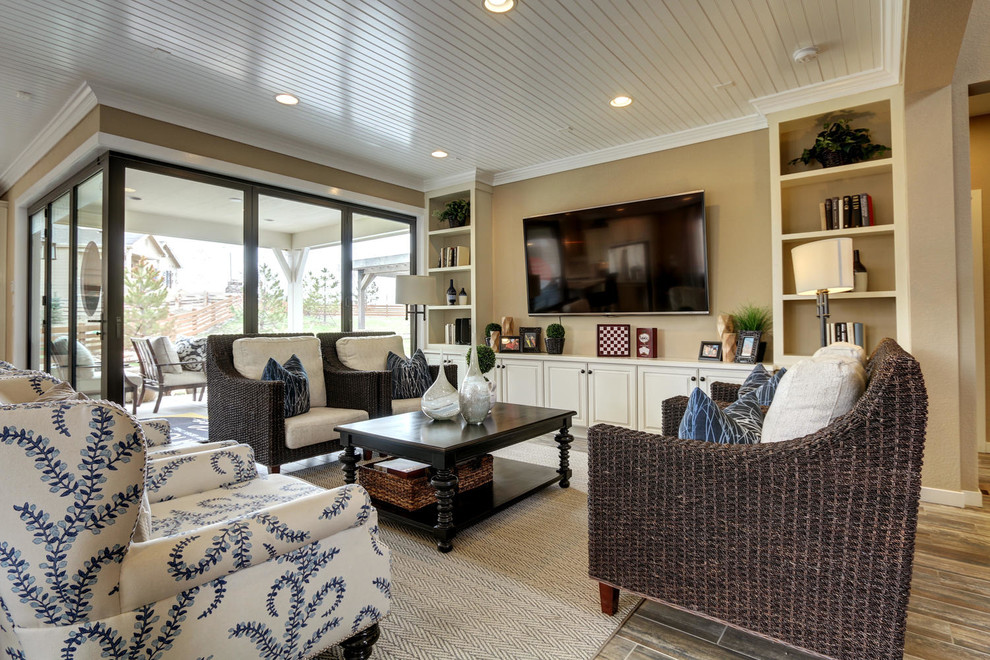 This is an example of a mid-sized transitional open concept family room in Denver with beige walls, vinyl floors, no fireplace and a wall-mounted tv.