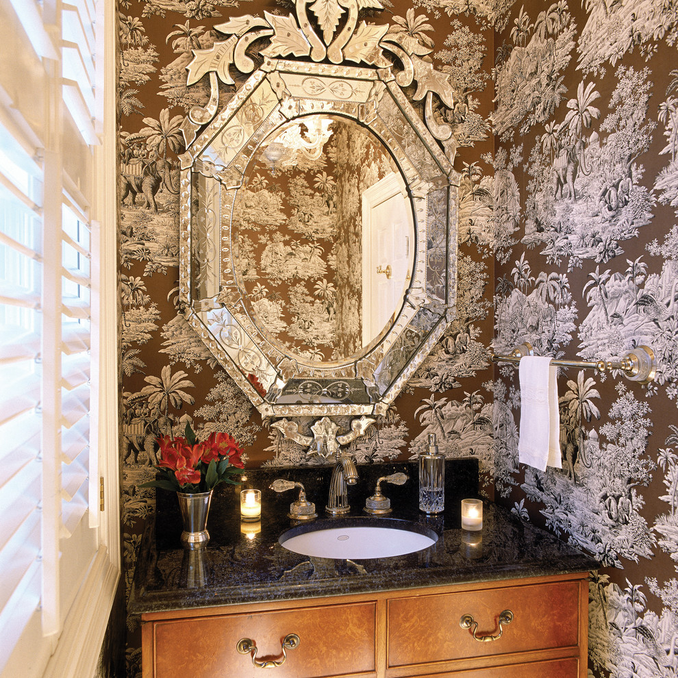 This is an example of a mid-sized traditional powder room in DC Metro with furniture-like cabinets and granite benchtops.