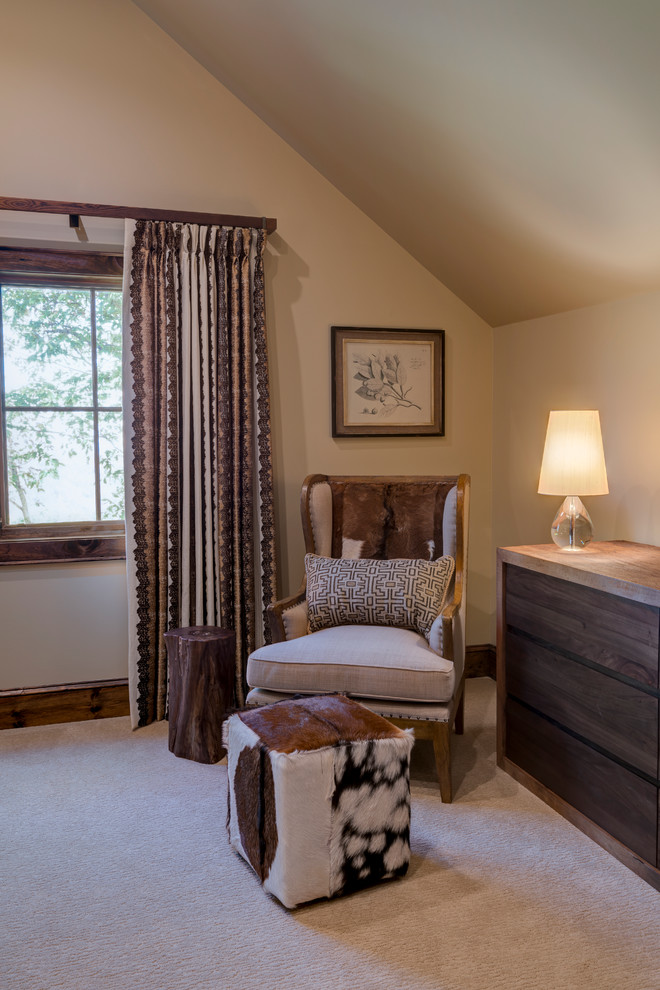 This is an example of a large country guest bedroom in Charlotte with beige walls, carpet, no fireplace and beige floor.