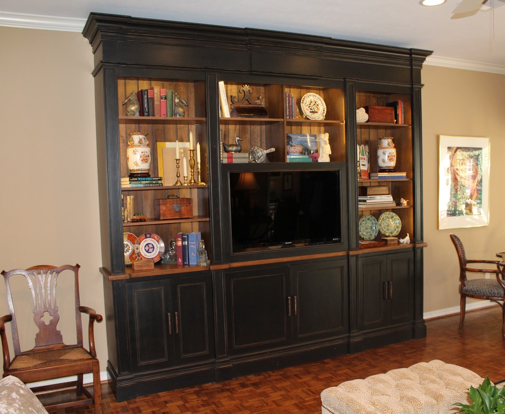 This is an example of a traditional family room in New Orleans with a concealed tv.
