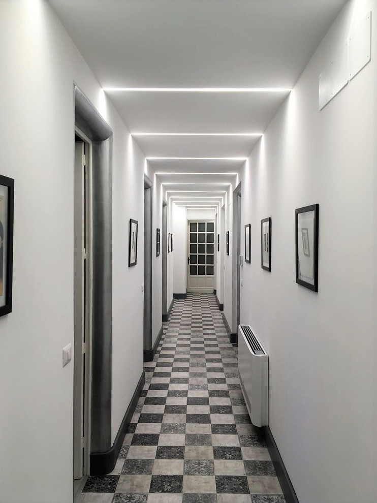 This is an example of a large traditional hallway in Catania-Palermo with white walls, vinyl floors and multi-coloured floor.