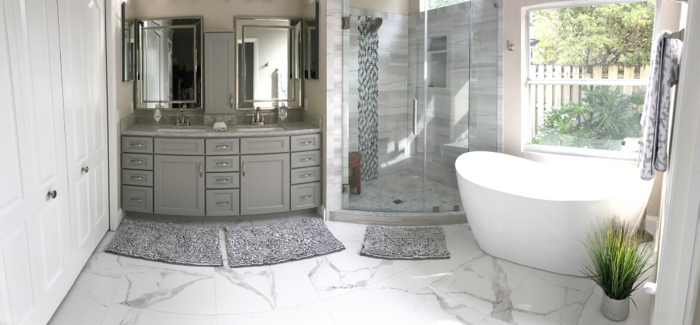 Photo of a large modern master bathroom in Jacksonville with shaker cabinets, grey cabinets, a freestanding tub, a corner shower, white tile, porcelain tile, porcelain floors, an undermount sink, quartzite benchtops, white floor, a hinged shower door and grey benchtops.