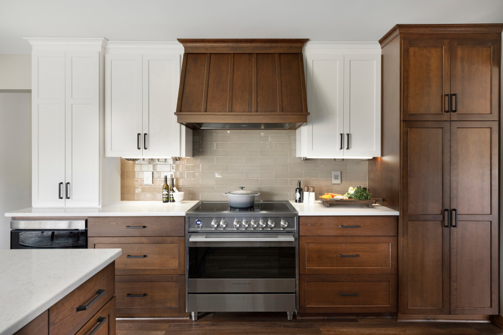 Large contemporary u-shaped eat-in kitchen in Minneapolis with a single-bowl sink, recessed-panel cabinets, medium wood cabinets, quartzite benchtops, beige splashback, glass tile splashback, stainless steel appliances, vinyl floors, a peninsula, brown floor, white benchtop and wood.