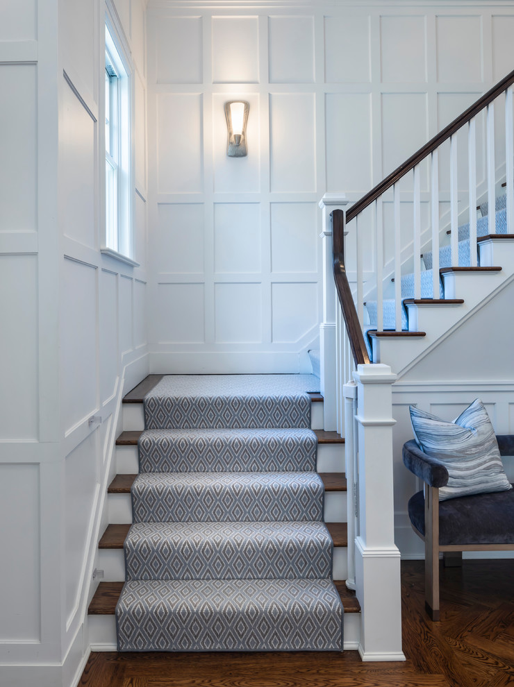 Large transitional carpeted l-shaped wood railing staircase photo in Miami with carpeted risers