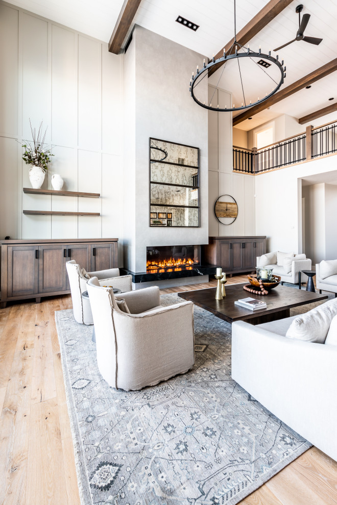 This is an example of a large classic open plan living room in Calgary with beige walls, light hardwood flooring, a two-sided fireplace, beige floors and a timber clad ceiling.