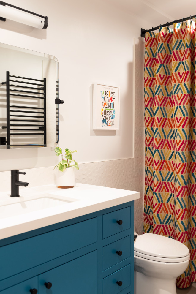 Example of a mid-sized transitional master mosaic tile floor and single-sink wet room design in San Francisco with flat-panel cabinets, a one-piece toilet, an undermount sink, quartz countertops, a hinged shower door, white countertops and a built-in vanity
