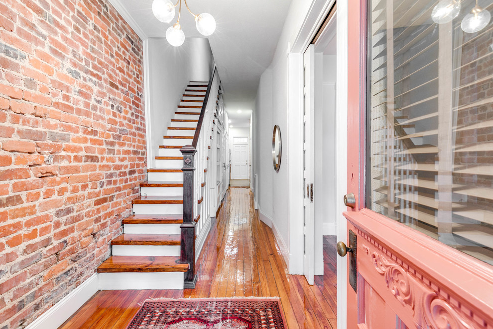 Large traditional hallway in Wilmington with grey walls and medium hardwood floors.