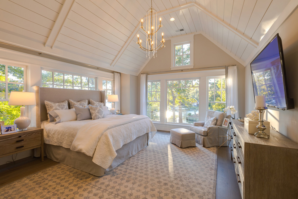 Example of a large beach style master medium tone wood floor and gray floor bedroom design in Other with gray walls