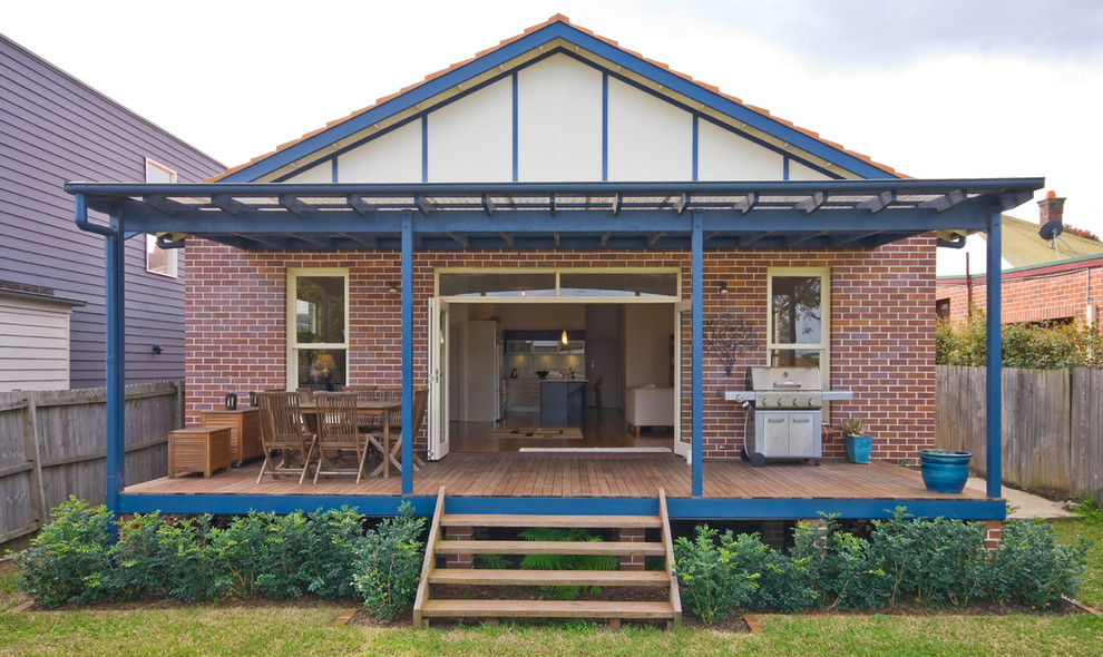 This is an example of a small traditional backyard patio in Sydney with decking and an awning.
