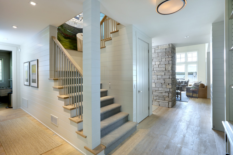 This is an example of a mid-sized traditional wood u-shaped staircase in Other with wood risers and wood railing.