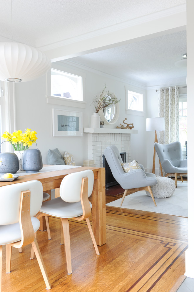 Inspiration for a small 1950s medium tone wood floor kitchen/dining room combo remodel in Vancouver with white walls and no fireplace