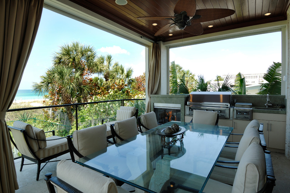 Photo of a mid-sized beach style balcony in Tampa with a roof extension.