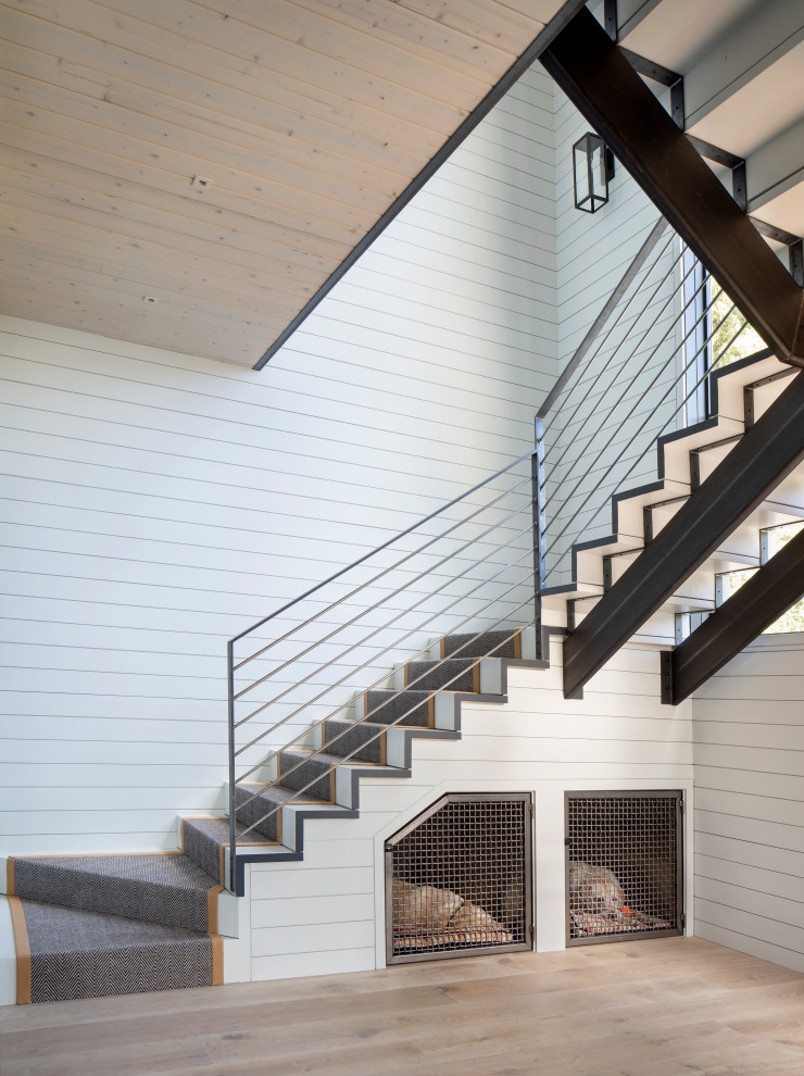 Modern staircase in Other with metal railing.
