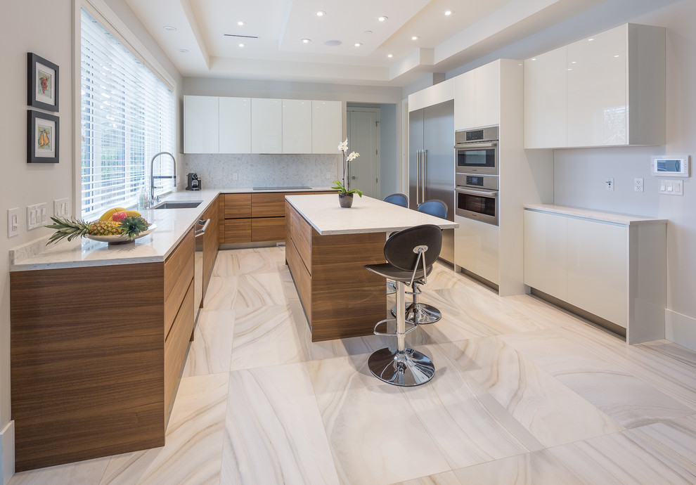 This is an example of a mid-sized modern u-shaped eat-in kitchen in Vancouver with flat-panel cabinets, medium wood cabinets, white splashback, marble splashback, stainless steel appliances, with island, an undermount sink, granite benchtops, marble floors and grey floor.