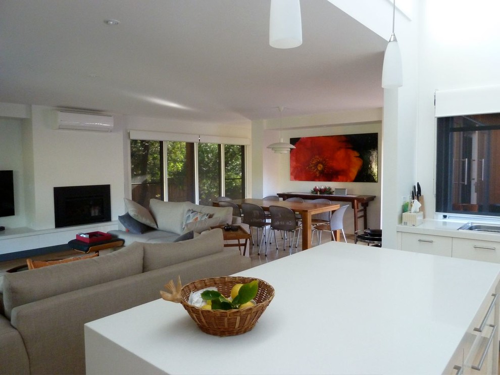 This is an example of a mid-sized beach style kitchen/dining combo in Geelong with white walls and light hardwood floors.