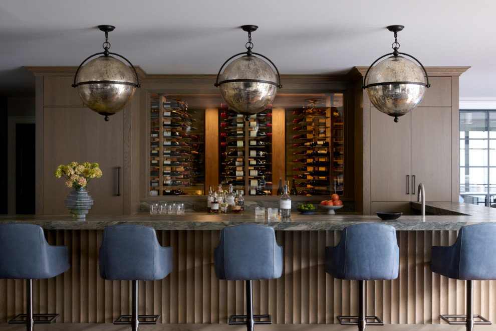 Inspiration for a transitional u-shaped home bar remodel in Philadelphia with flat-panel cabinets, brown cabinets and gray countertops
