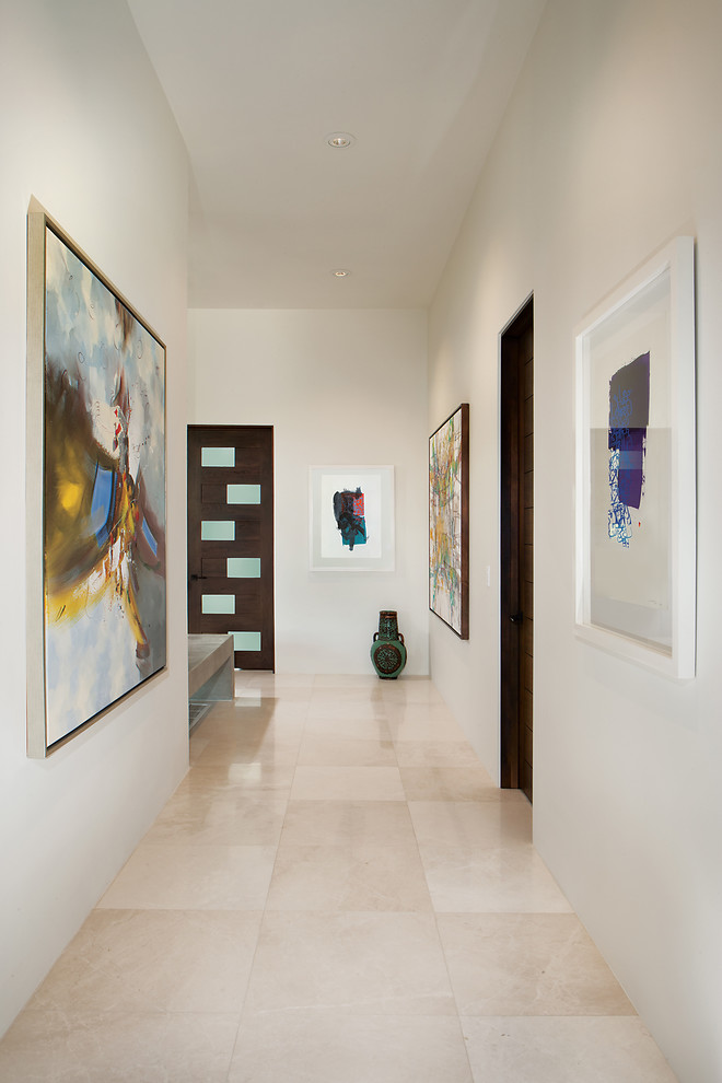 This is an example of a mid-sized contemporary hallway in Phoenix with white walls, marble floors and white floor.