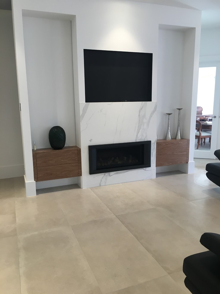This is an example of a large modern formal open concept living room in Adelaide with white walls, porcelain floors, a hanging fireplace, a stone fireplace surround and a built-in media wall.