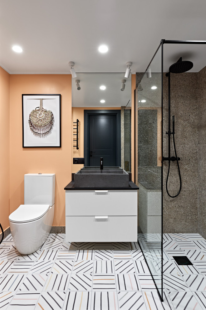 Пример оригинального дизайна: ванная комната среднего размера в скандинавском стиле с белыми фасадами, душем в нише, унитазом-моноблоком, коричневой плиткой, керамогранитной плиткой, оранжевыми стенами, полом из керамической плитки, накладной раковиной, столешницей из искусственного камня, разноцветным полом, шторкой для ванной, серой столешницей, тумбой под одну раковину и подвесной тумбой