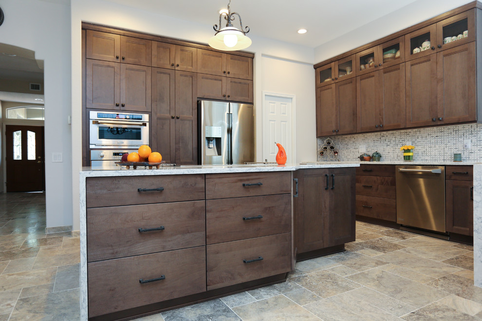 Inspiration for a porcelain tile kitchen remodel in Phoenix with an undermount sink, shaker cabinets, gray cabinets, quartz countertops, white backsplash, ceramic backsplash, stainless steel appliances and an island