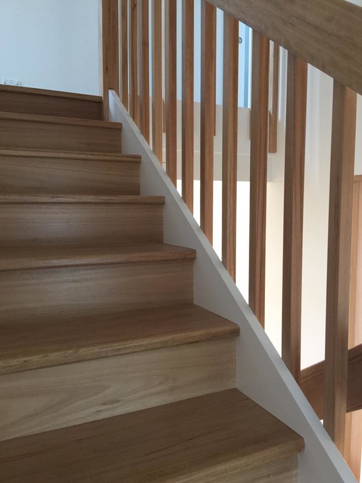 This is an example of a medium sized contemporary wood l-shaped staircase in Sydney with wood risers.