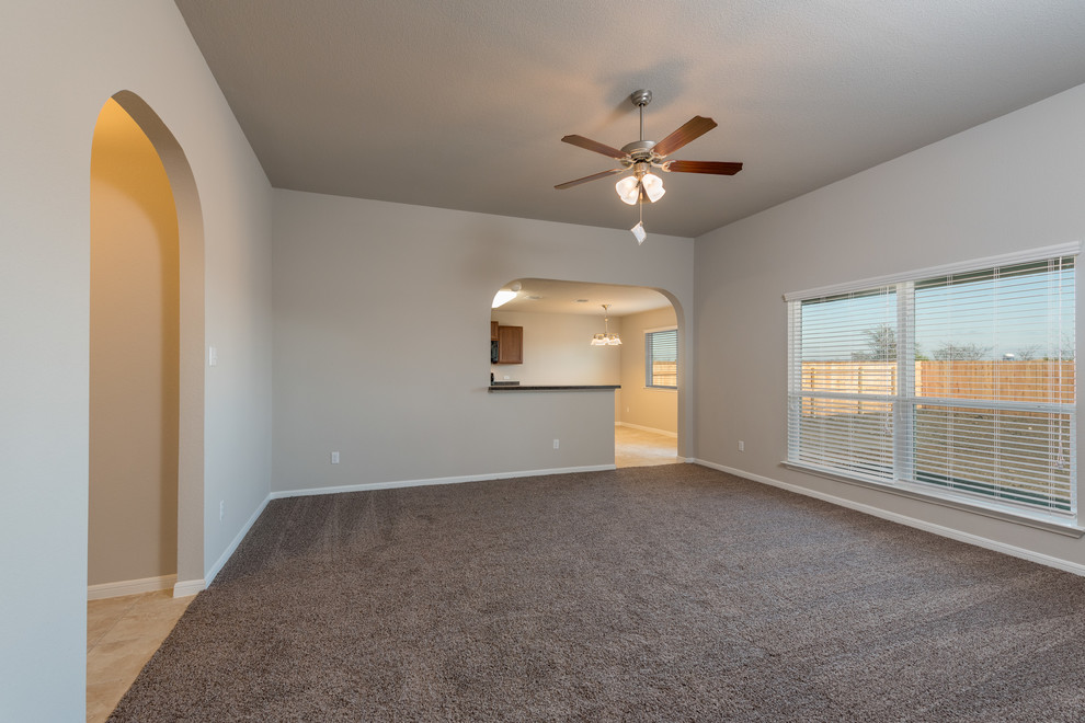 Mid-sized transitional enclosed family room in Austin with beige walls, carpet, no fireplace, no tv and beige floor.
