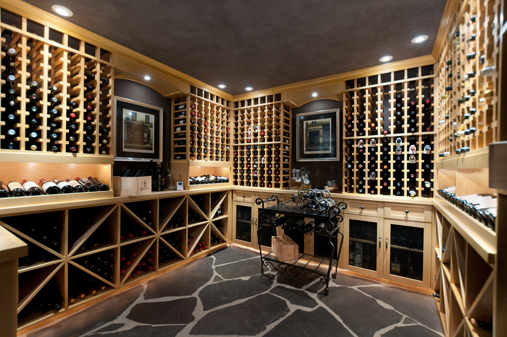 Design ideas for a traditional wine cellar in Vancouver with storage racks and black floor.