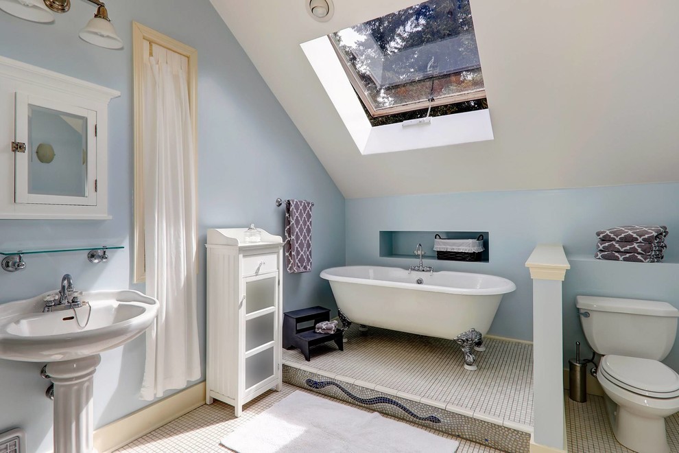 Inspiration for a mid-sized transitional bathroom in West Midlands with white cabinets, a claw-foot tub, a shower/bathtub combo, a one-piece toilet, blue walls, mosaic tile floors, a console sink and white floor.