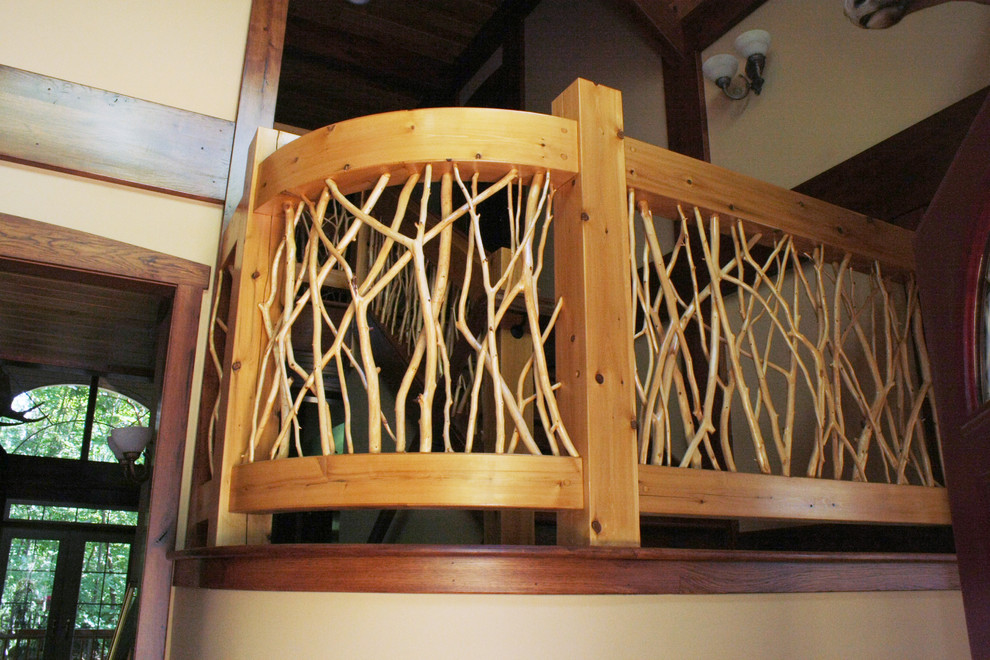 This is an example of a country wood u-shaped staircase in Detroit with wood risers.